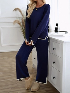Detailed knit texture of navy long-sleeve top and wide-leg pants with white stripes