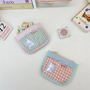 Flat lay view of quilted cotton zipper pouches with grid patterns and bear decorations