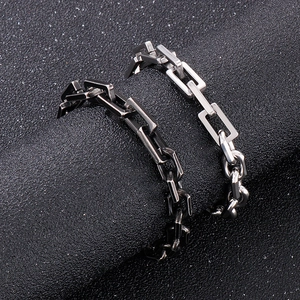 Macro view of rectangular chain links in polished silver and matte gunmetal finishes