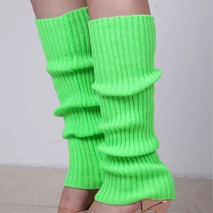 Detailed close-up of neon green knitted leg warmers with thick ribbed texture