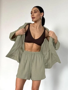 Detailed texture of sage green linen blend shirt and matching drawstring shorts