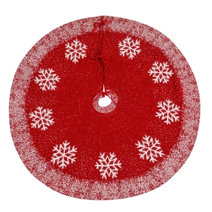 Red knitted Christmas tree skirt with white snowflake patterns and plush fur trim