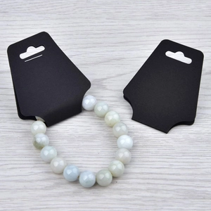 Detail of beaded gemstone bracelet displayed on a professional black kraft card