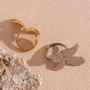 Detailed macro view of adjustable butterfly rings in gold and silver stainless steel