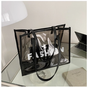 Detailed macro view of a grey transparent PVC tote bag with stylish black trim and fashion text