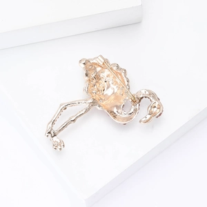 Detailed back view of golden flamingo brooch showing the secure pin fastener structure