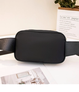 Detail of the high-quality black nylon waist bag with smooth zipper and wide strap