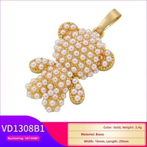 Detailed close-up of golden brass teddy bear pendant with pearl inlay measurements