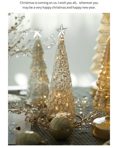 Close-up of glass Christmas tree decor with warm LED lights and vintage mercury texture