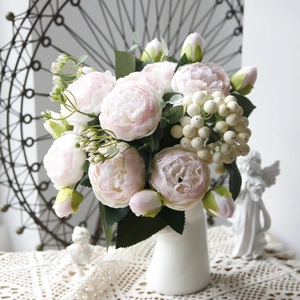 Detailed shot of pink peony bouquet with white berries in a vase for home decor