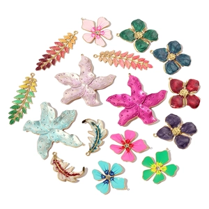 Detailed macro view of colorful enamel flower and leaf charms for DIY jewelry making