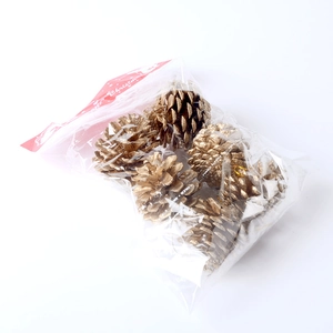 Set of six golden pine cone Christmas ornaments in a festive Merry Christmas package