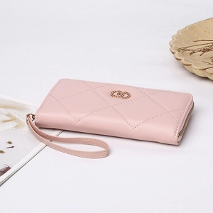 Close-up of pink long quilted wallet with gold ring logo and metal zipper detail