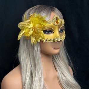 Detail of luxury gold masquerade mask with large side flower and crystal drop gemstone