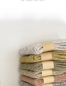 Close-up of assorted wool knit socks in earthy tones with thick ribbed texture details