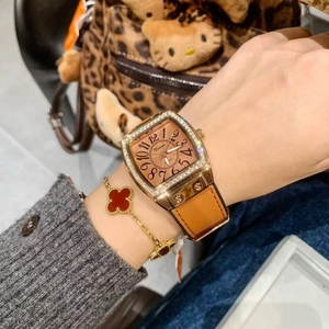 Rose gold tonneau watch with crystal bezel, brown strap and clover bracelet set