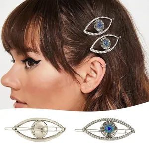 Sparkling Evil Eye punk hair clip with white rhinestones and blue center detail
