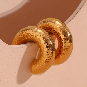 Detail of 18K gold-plated stainless steel earrings with textured hammered finish