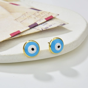 Detailed macro shot of the colorful evil eye stud earrings on a ceramic dish background