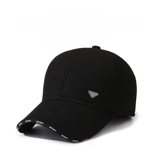 Close-up of black winter baseball cap with ear flaps and iconic metal triangle plaque
