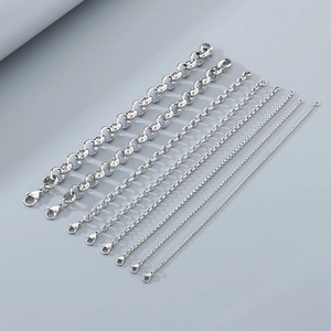 Macro view of eight various sizes of silver stainless steel chains with lobster clasps