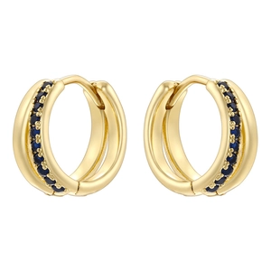 Macro detail of gold huggie hoop earrings with pave-set deep blue round gemstones