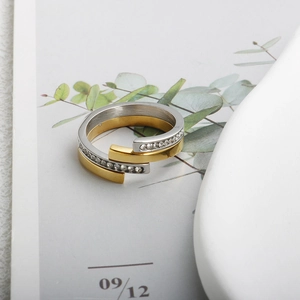 Detail of double-layer rose gold and silver steel ring with pavé diamonds