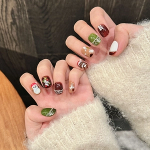 Handmade Christmas press-on nails featuring 3D snowman, reindeer, and festive art