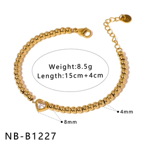 Detail of 18K gold plated beaded bracelet with heart pendant and zirconia main stone