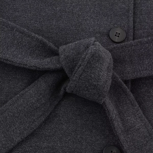 Dark grey wool coat for women with waist belt tie and button detail in close-up view