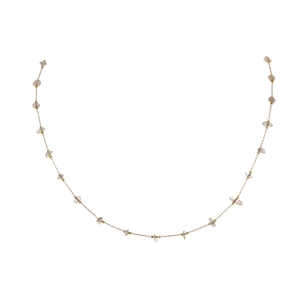 Detailed shot of golden stainless steel station necklace with natural crushed quartz stones