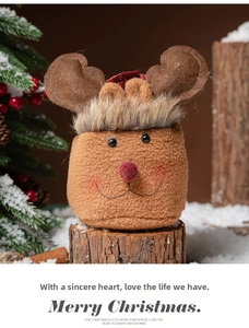 Detail of reindeer-shaped Christmas drawstring gift bag with fluffy texture and antlers