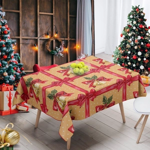 Close-up of Christmas tablecloth with red ribbons and golden bells on a rustic wooden table