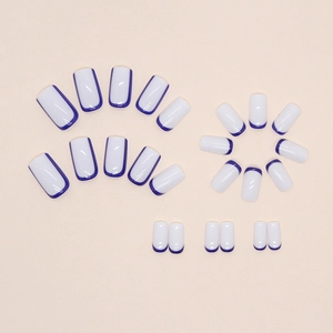 Morandi press-on nails with white base and dark blue French tip design, almond shape