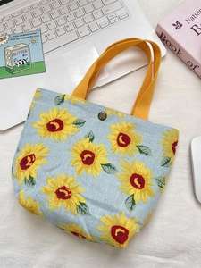 Light blue sunflower canvas tote bag with yellow handles and metal button closure