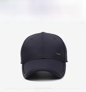Close-up of navy blue cotton baseball cap with a small rectangular metal plate detail