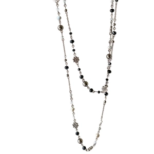 Double-layered beaded flower necklace with crystal beads and metal charms on white background