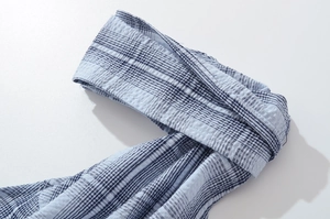 Detail shot of blue plaid seersucker fabric with pleated texture and woven pattern