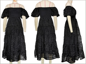 Detail view of the black off-shoulder tiered dress with smocked bodice and puff sleeves