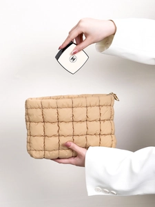 Stylish quilted beige cosmetic bag with puffy pleated design for modern women