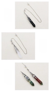 Macro detail of obsidian, clear quartz, and indian agate hexagonal crystal pendulum necklaces