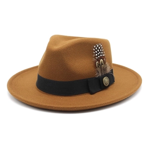 Detail of brown wool fedora hat featuring black grosgrain ribbon and feather accent