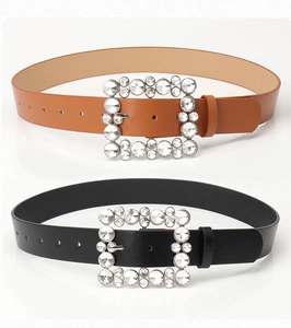 Detail of black and brown women's leather belts featuring luxury square rhinestone buckles