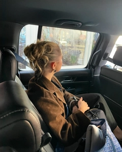 Detail of red faux suede oversized blazer and designer tote bag in a luxury car