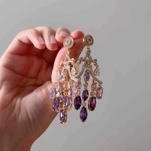 18K gold plated water drop earrings with purple zircon and long tassels held in hand