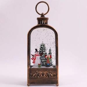 Close-up of vintage bronze Christmas lantern featuring a snowman scene and snow effect