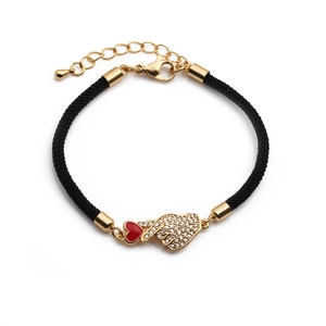 Detailed view of woven bracelet with gold hand sign charm and adjustable lobster clasp