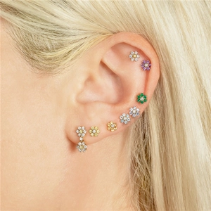 Detailed view of mini S925 flower stud earrings with colorful zircon stones on ear