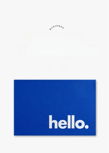 Detail of navy blue PVC loop pile doormat with white hello you are here text
