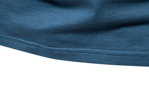 Macro shot of double-needle hem stitching on a navy blue cotton V-neck t-shirt